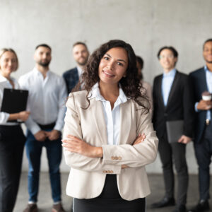 Successful,Business,Team.,Mexican,Businesswoman,Standing,In,Front,Of,Her